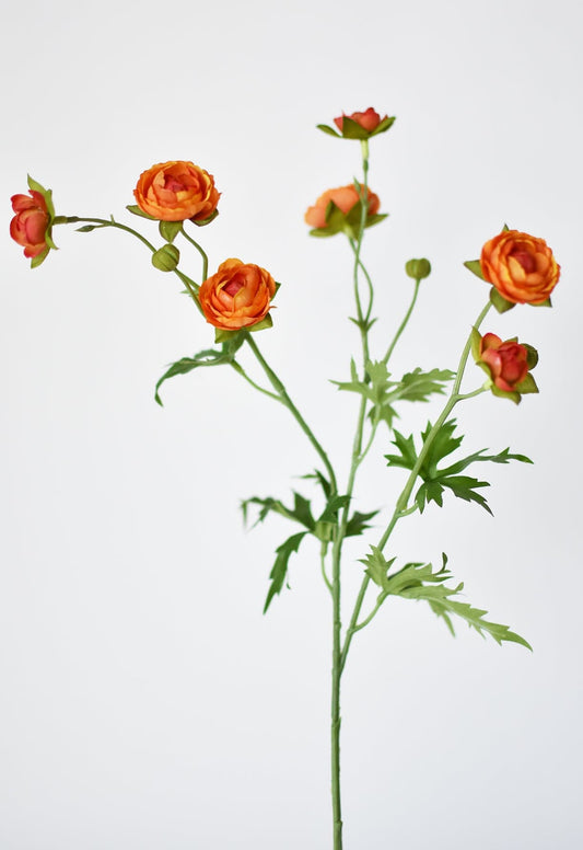 Artificial ranunculus flower stem with orange flowers on a light gray background