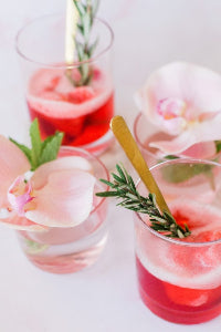 Refreshing summer cocktail served with designer cocktail napkins for outdoor entertaining, backyard parties, dinner parties, and elegant summer gatherings.