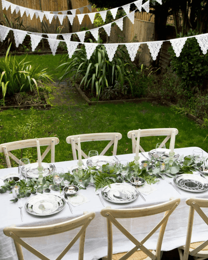 Elevate your wedding decor with our gorgeous White Cotton Pennant Flag Banner. This shabby chic bunting features alternate lace-edged and plain triangles, providing a beautiful and romantic touch to your special day. The White Cotton Pennant Flag Banner measures 11.5 feet in length, with 14 flags each measuring 7.25 inches wide and 8.5 inches long. The high-quality cotton fabric used in this bunting ensures durability and longevity, making it a great investment for your wedding decor. Our White Cotton Penna