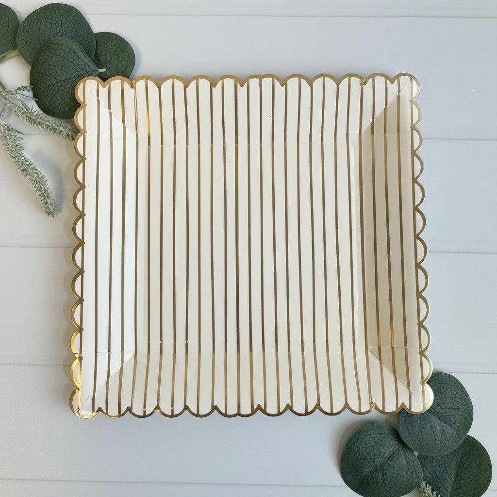 Decorative square plate with scalloped edge on a light wooden surface.