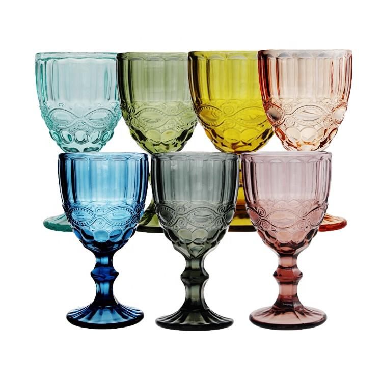 Set of colorful glass goblets on a white background