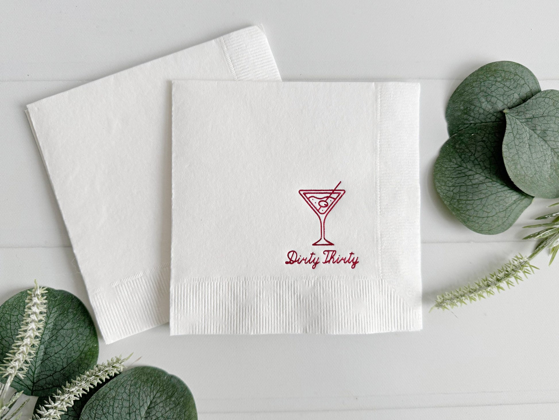 Celebrate your 30th in style with our Dirty Thirty Martini Glass Cocktail Napkins, designed to bring sophistication and fun to your milestone birthday party. These premium white cocktail napkins feature a chic martini glass design and "Dirty Thirty" in luxurious plum foil script