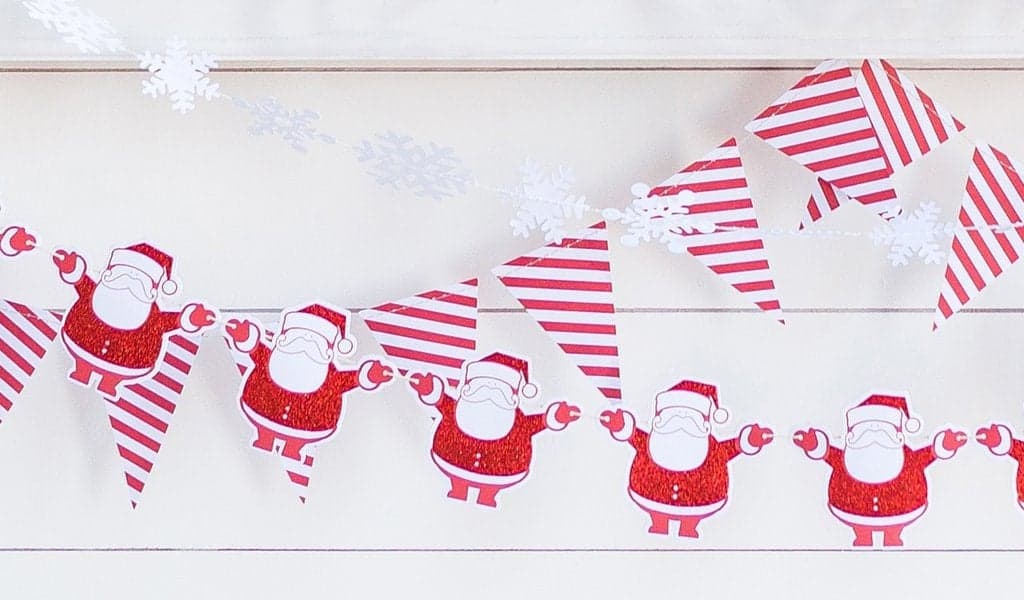 Snowflake Garland Layered with a santa and red striped garland for a Baby It's Cold Outside party.