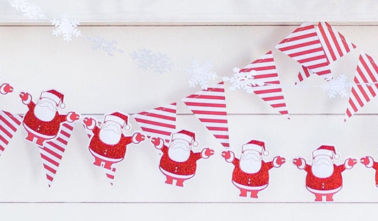 Snowflake Garland Layered with a santa and red striped garland for a Baby It's Cold Outside party.