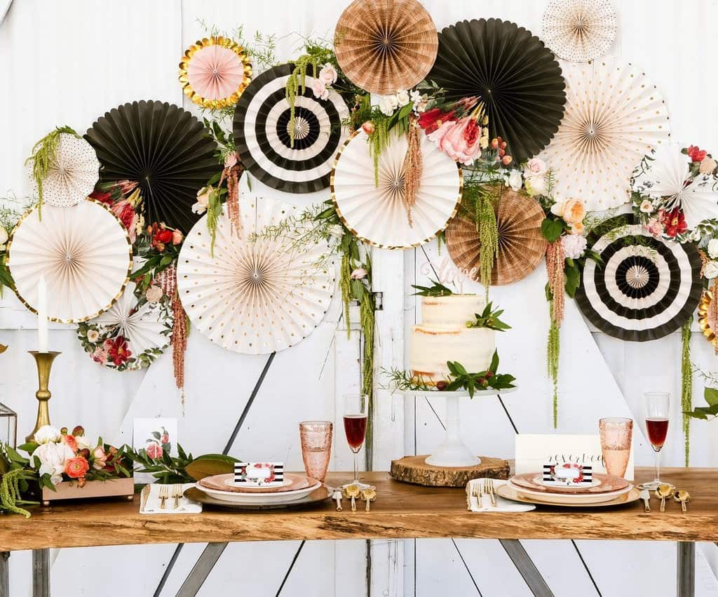 Floral Bridal Shower Photo Backdrop in Black, Cream, Kraft and Gold behind a cake.