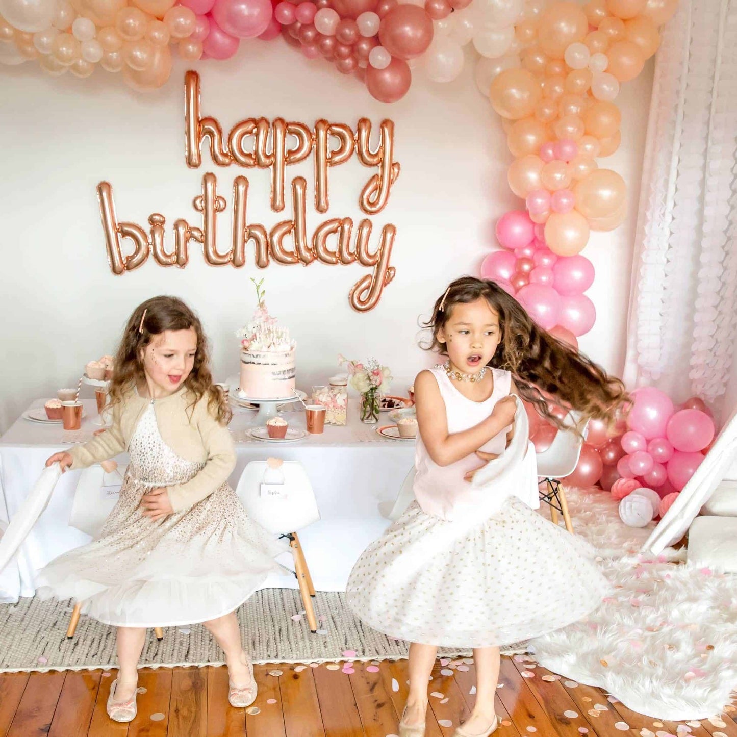 HAPPY BIRTHDAY in rose gold mylar script letter balloons spelling out the birthday greeting. Perfect for a photo booth backdrop, behind the birthday cake, or in an entrance to an event!