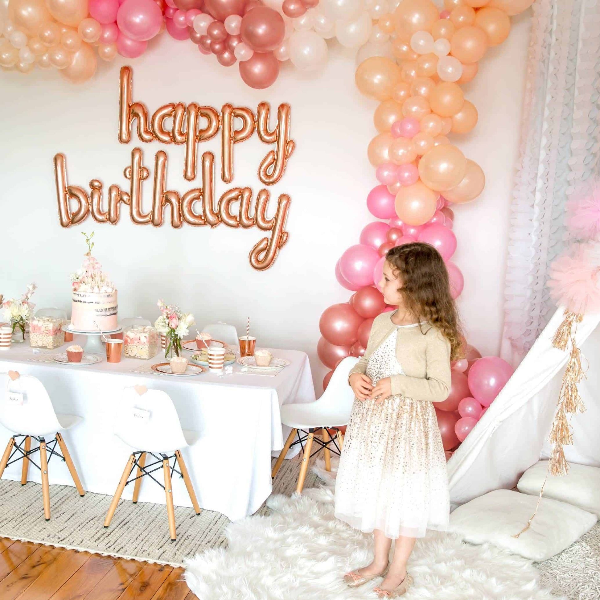 HAPPY BIRTHDAY in rose gold mylar script letter balloons spelling out the birthday greeting. Perfect for a photo booth backdrop, behind the birthday cake, or in an entrance to an event!
