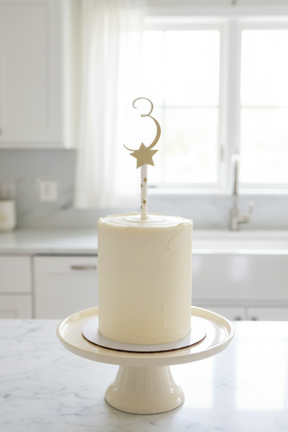 Gold 3 star topper on tall cream cake