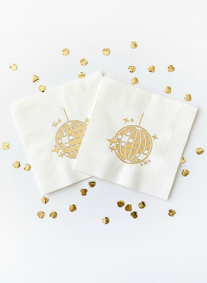 Gold disco ball napkins on white background with confetti