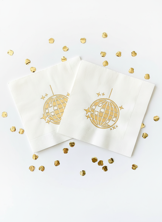 Gold disco ball napkins on white background with confetti