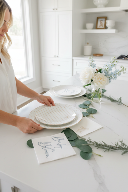Hands arranging bow plates with blue napkins
