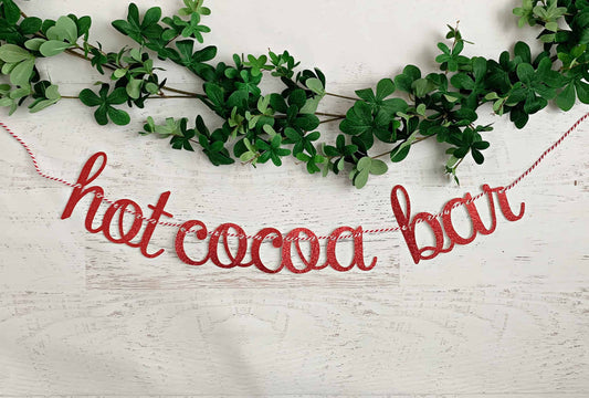 Hot Cocoa Bar banner in red glitter on red and white twine for your hot chocolate bar setup.