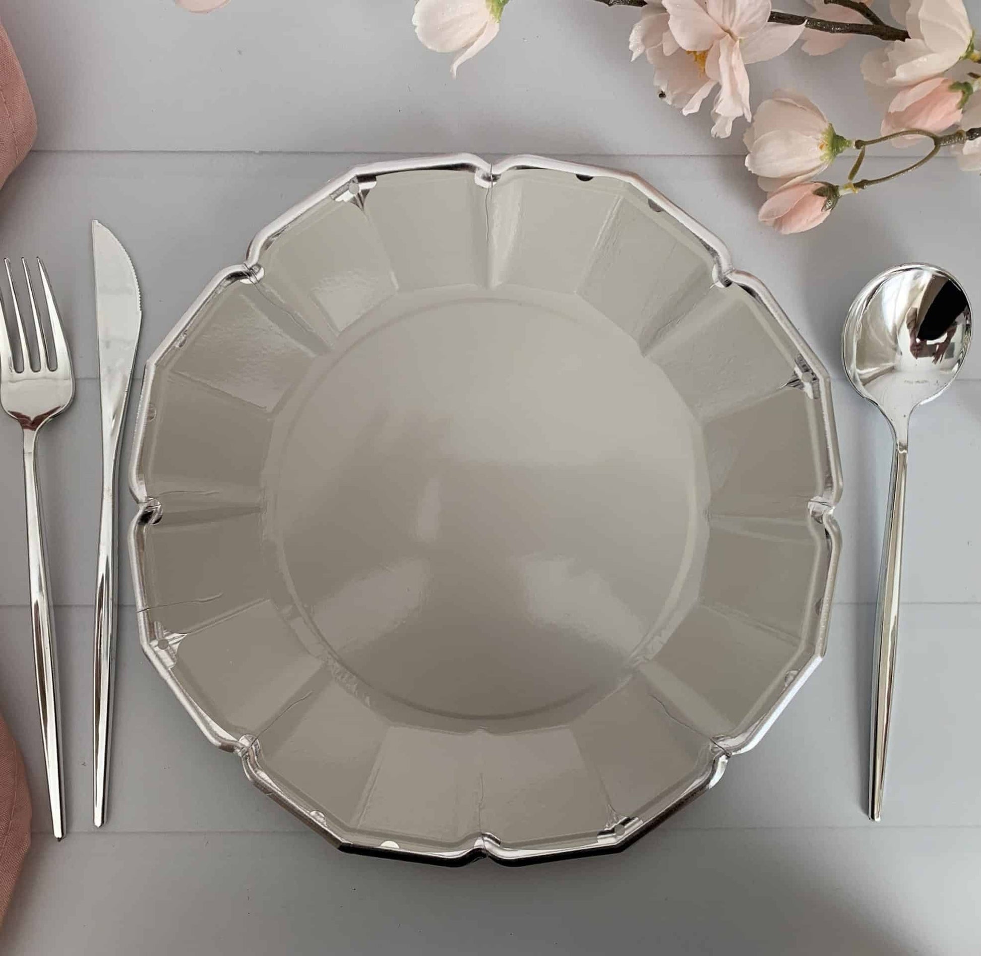 Add an elegant touch to your 25th anniversary or birthday celebration with our Grey Scalloped Dinner Plates with a Silver Foil Edge. These 10" plates are the perfect size for your guests to enjoy a delicious meal, while the elegant silver foil edge adds a touch of sophistication to your party decor.