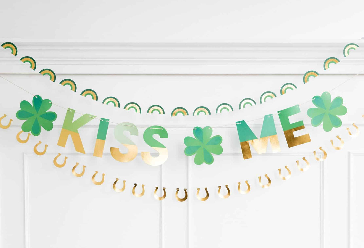 Kiss Me Shamrock banner with gold and green letters for St. Patrick's Day