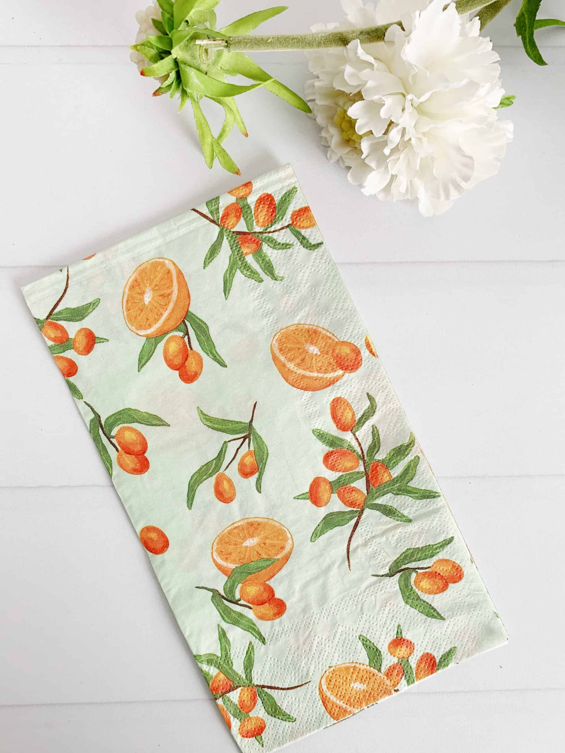 Little Cuties Citrus Clementine Dinner napkins or guest towels on a soft sage background.