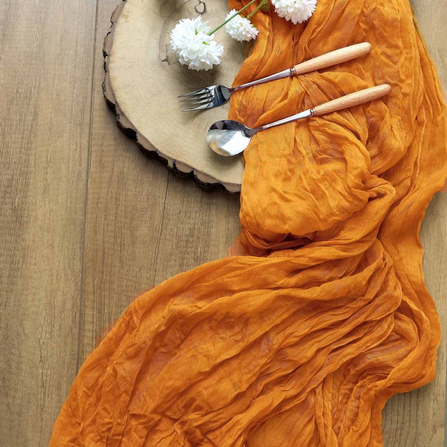 Mustard Gauze Table Runner made from an amber orange cheesecloth material.