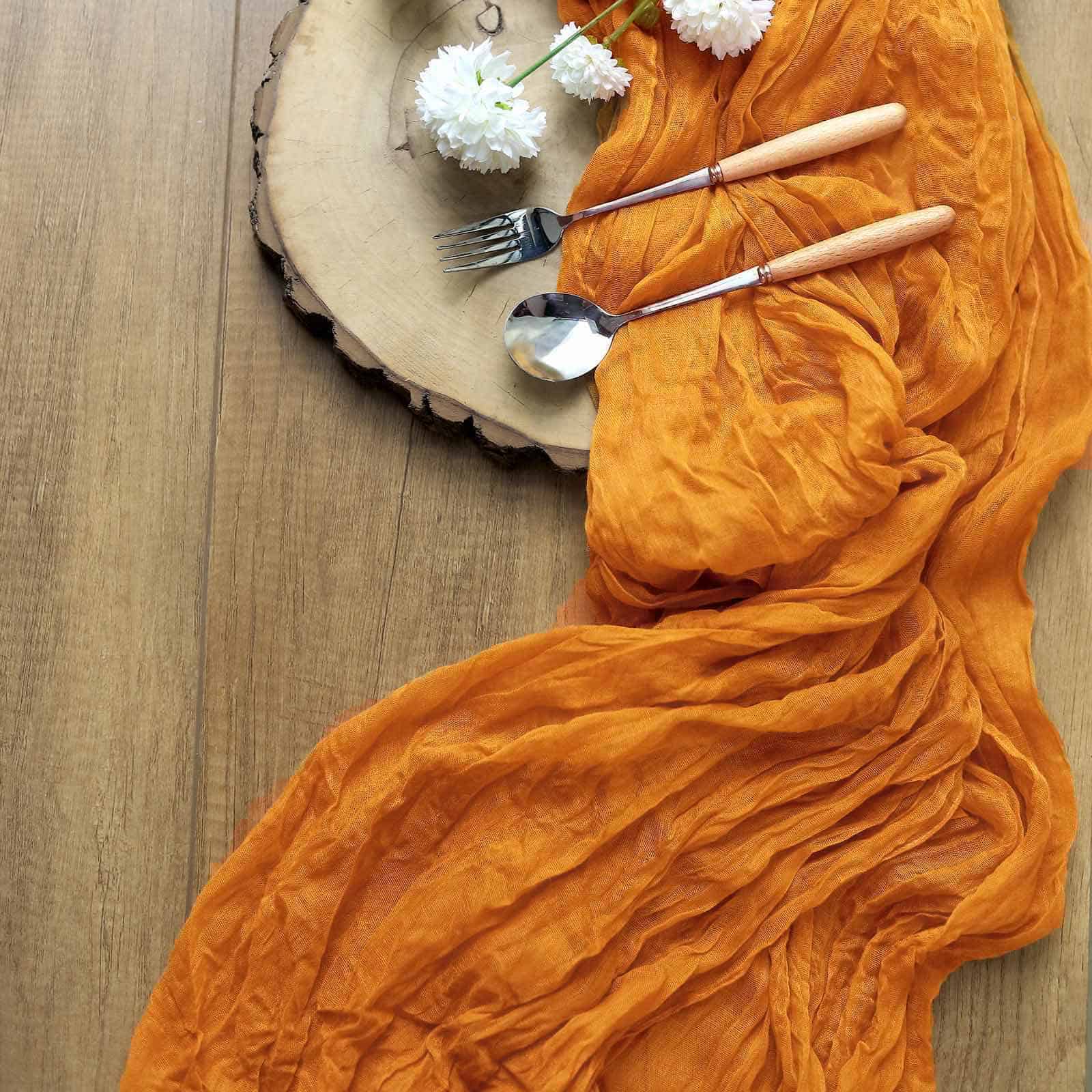 Mustard Gauze Table Runner made from an amber orange cheesecloth material.