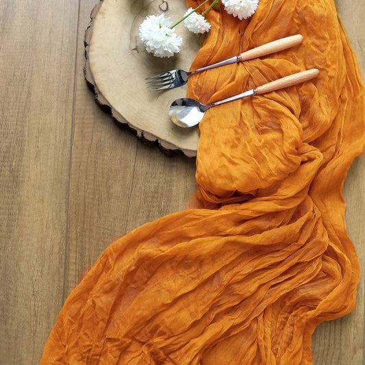 Mustard Gauze Table Runner made from an amber orange cheesecloth material.