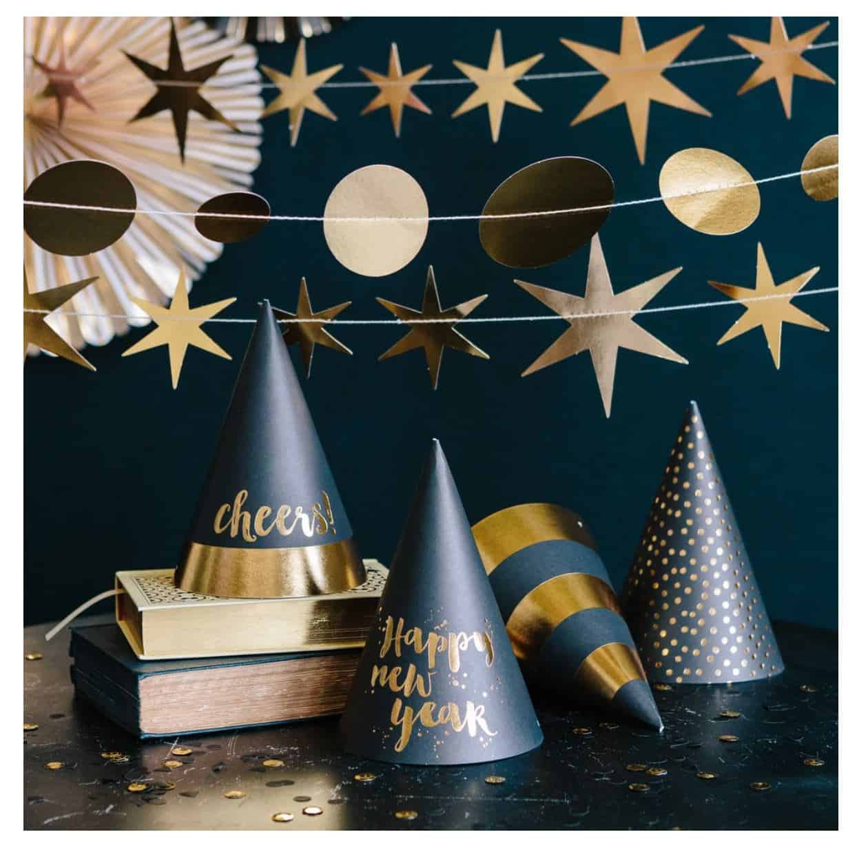 gold and black NYE party hats make the perfect New Year's Eve photo booth props. Kiss at midnight under the flair of a fun party hat.