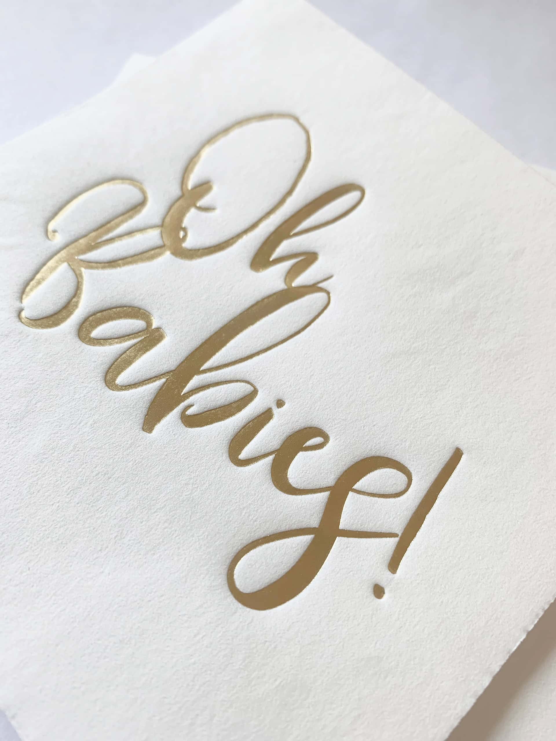 The gorgeous gold foiled scripted writing on these Oh Babies cocktail napkins looks elegant on a neutral white background. Use the napkins for treats and to protect those baby shower outfits! All that's left to do is enjoy this special moment at the twin's baby shower with family and friends.