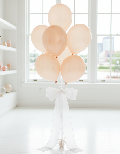 Opaque peach pearl balloon bouquet with white organza ribbons