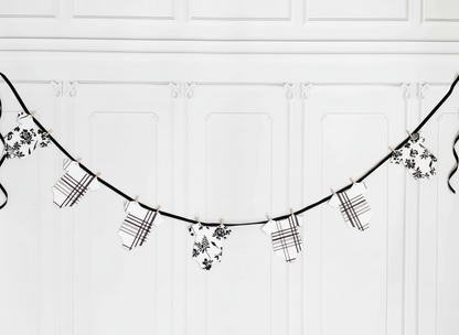 Overhead flat lay of plaid onesie banner