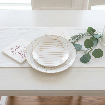 Overhead place setting with bow plates and pink napkins