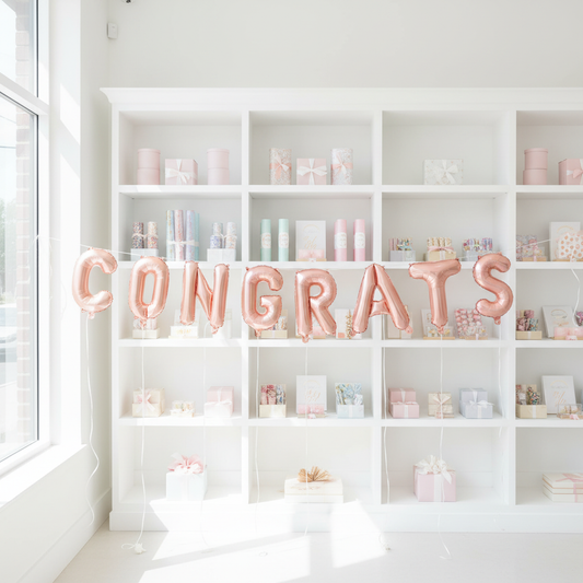 Rose Gold Congrats Letter Balloons in Front of Bookcase
